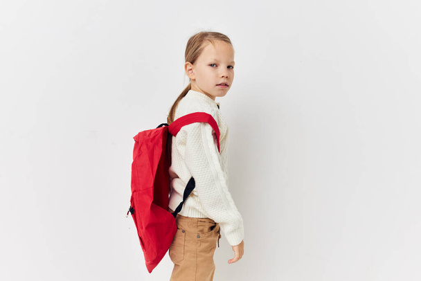 pretty young girl school backpack with a hat on his head isolated background - 写真・画像