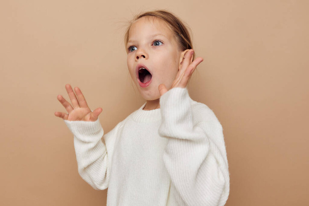 little girl childrens style emotions fun beige background - Φωτογραφία, εικόνα