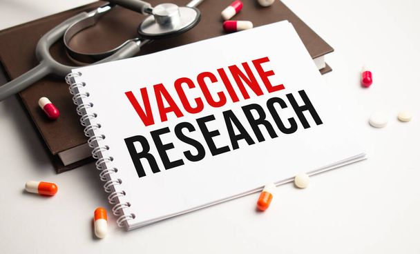 VACCINE RESEARCH abbreviation on the notepad with stethoscope - Photo, image
