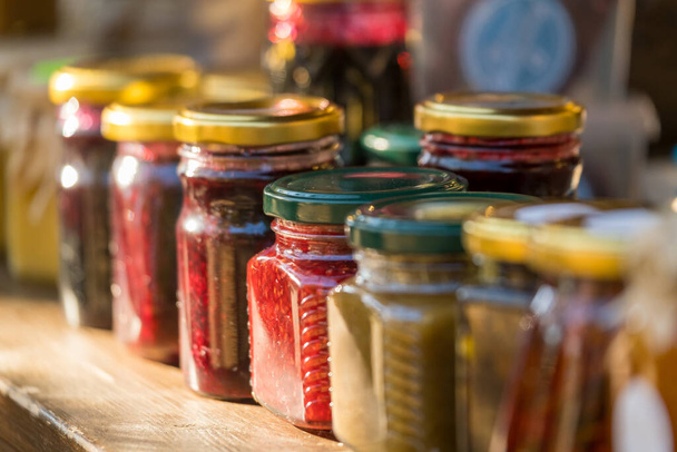 Jars with assorted jams on stall - Photo, Image
