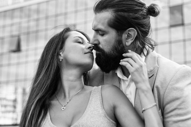 Love story. couple in love. feel the romance. first meet date. celebrate romantic holiday. family anniversary. pure feelings. bearded man hipster hug sexy woman. guy kiss his girl outdoor - Foto, afbeelding