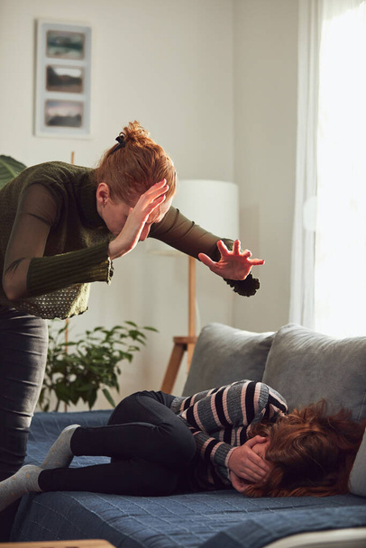 Teenage girl in difficult mood with angry mom. - Foto, imagen