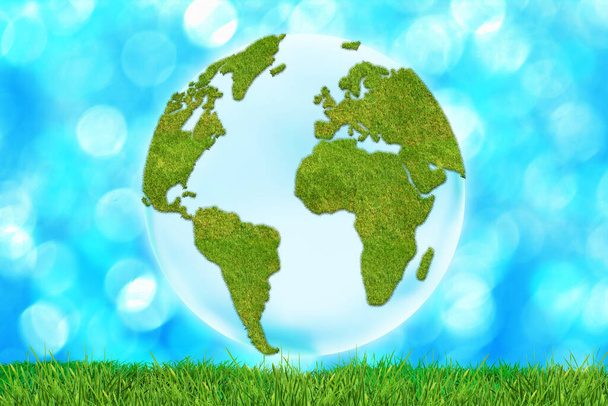 3D Erdkugel mit Kontinenten aus Gras auf blauem defokussierten Hintergrund mit Gras - Foto, Bild