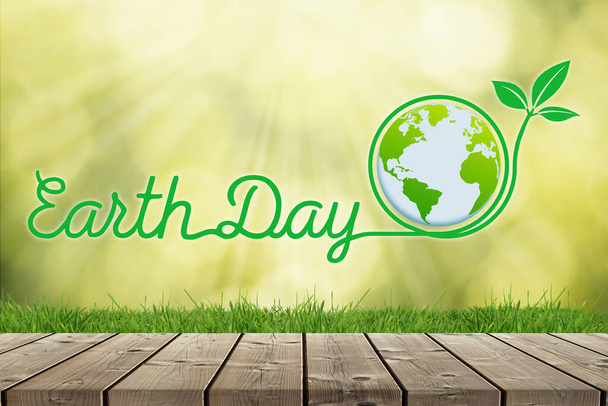 Earth Day tło z Ziemi globus na zielonym tle zdekoncentrowany z trawy i podłogi z drewna - Zdjęcie, obraz
