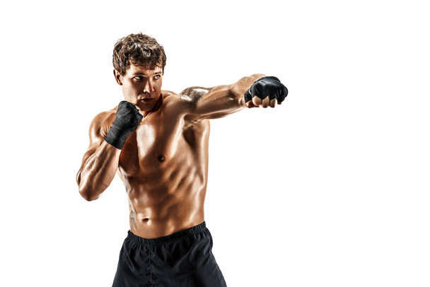 Portrait of male boxer who training and practicing jab on white background. sport, healthy lifestyle - Фото, изображение