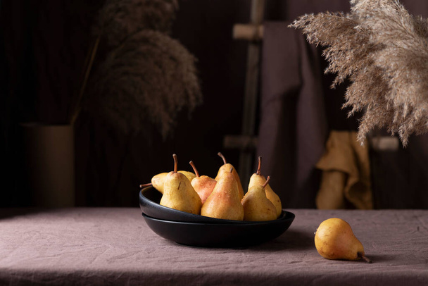 Sweet pears in rustic style on the dark background, selective focus image - Photo, image