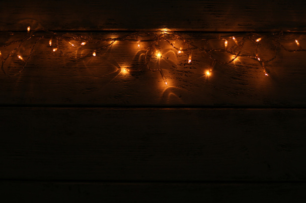 Christmas lights on wooden background - Photo, Image