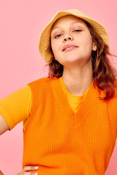 beautiful woman in an orange sweater in yellow hat hand gesture isolated backgrounds unaltered - Foto, imagen