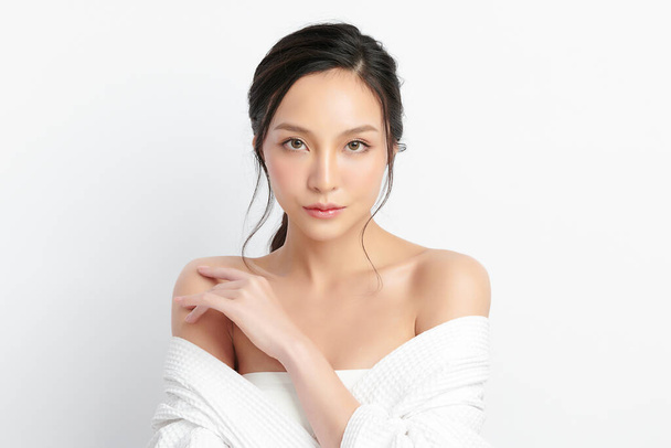 Belle jeune femme asiatique en peignoir sur fond blanc, Soins du visage, Soins du visage, Cosmétologie, Beauté et Spa Concept. - Photo, image