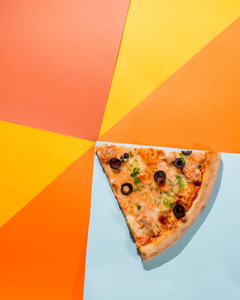 Pizza slice triangle on a colored bright background. Concept for pizzerias - 写真・画像