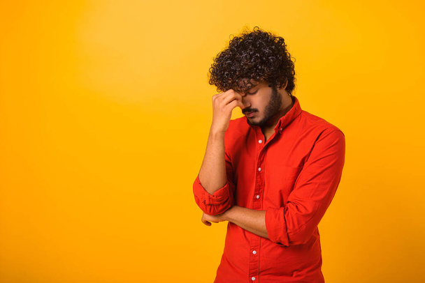 Problem, depression or sickness. Portrait of sad alone handsome young bearded man in shirt standing, holding head down and crying - Photo, Image