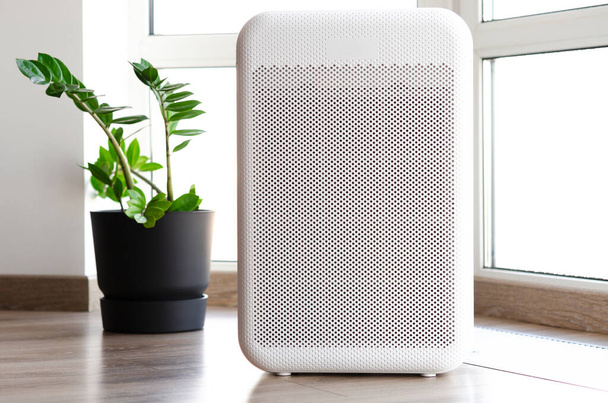 Air purifier in cozy home for filter and cleaning removing dust PM2.5 HEPA and virus in home,for fresh air and healthy Wellness life,Air Pollution Concept - Photo, Image