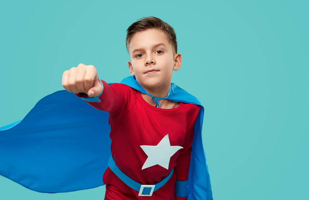 Brave boy in superhero costume in studio - Foto, Imagen