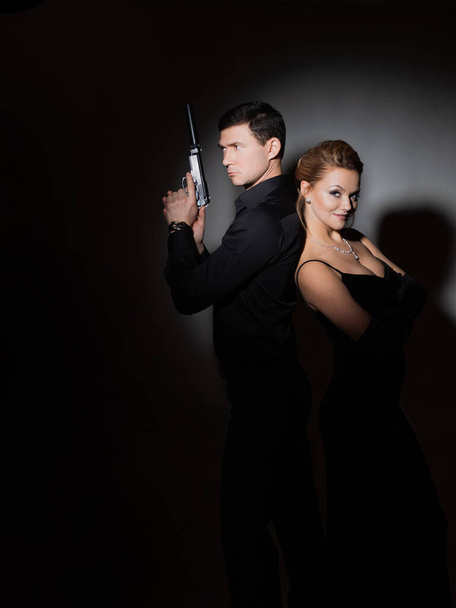 A pair of spy-style portraits, a gorgeous blonde in a black evening dress - Фото, изображение
