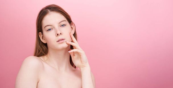 Close-up shot of young woman on pink background.  - Foto, Imagen