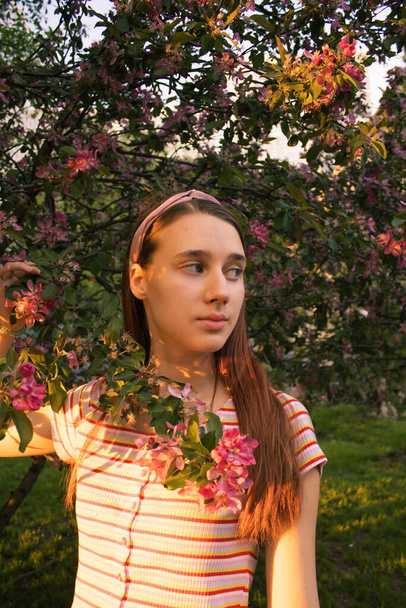 Portrait of a young girl in a blooming apple tree. Spring. Bloom. Hope for the best. Generation Z.  - Φωτογραφία, εικόνα