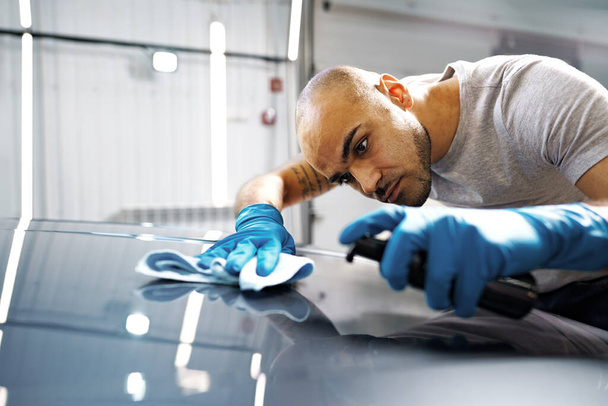 African American man car service worker applying nano coating on a car - Photo, image