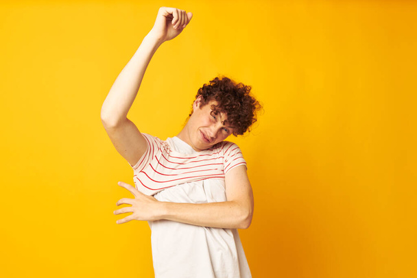 portrait of a young curly man striped t shirt posing summer clothing isolated background unaltered - 写真・画像
