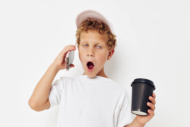 Little boy what kind of drink is the phone in hand communication lifestyle unaltered - Fotó, kép
