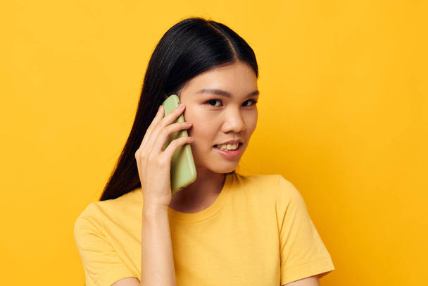 Portrait Asian beautiful young woman phone communication fun use studio model unaltered - Valokuva, kuva
