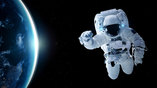 Astronaut spaceman do spacewalk while working for spaceflight mission - Photo, Image