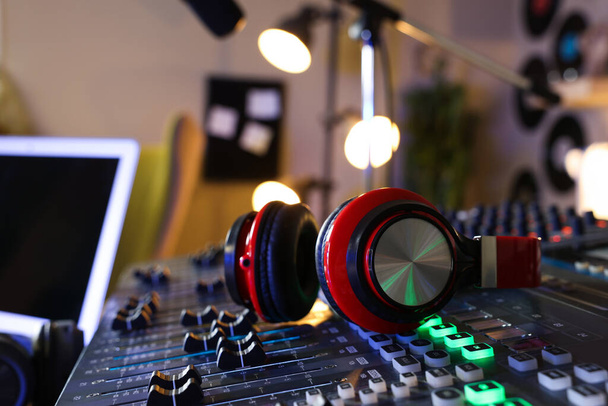 Headphones on professional mixing console in radio studio - Fotografie, Obrázek