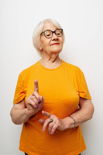 Photo of retired old lady in casual t-shirt and glasses close-up - Fotografie, Obrázek