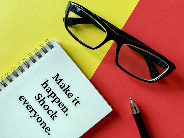 Motivational and inspirational concept - Make it happen. Shock everyone. With glasses, pen, yellow and red background. Motivational concept. - Foto, Imagen