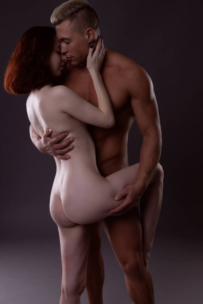 Attractive naked lovers man and woman experiencing a passionate moment together - Photo, Image