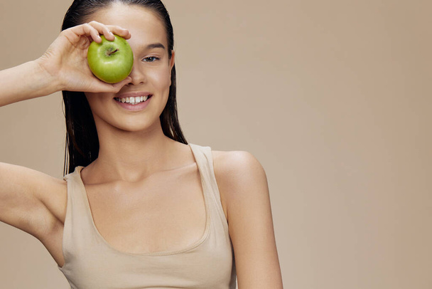 beautiful woman green apple near face health isolated background - Photo, Image