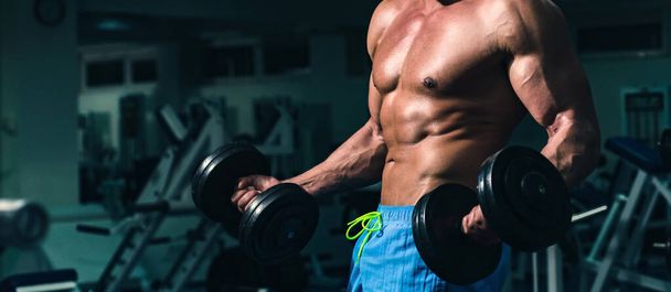 Banner templates with muscular man, muscular torso, six pack abs muscle. Guy in gym. Sporty male with naked torso. Workout. Exercises with dumbbells. Powerful athletic body. Sportsman. - Photo, Image