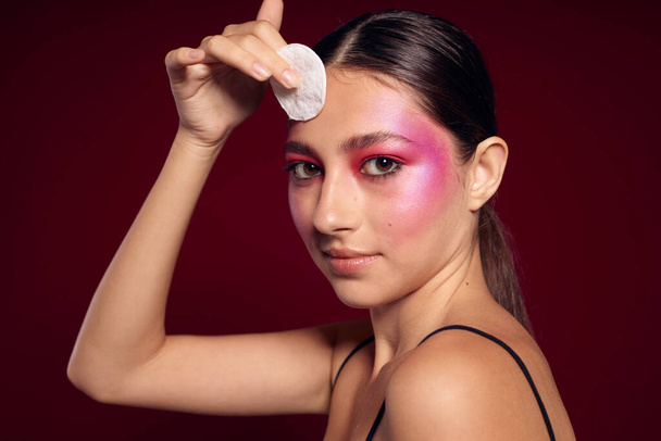 Beauty fashion female pink face makeup posing attractive look skin care pink background unaltered - Foto, Imagen