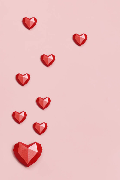 Volumetric paper hearts red colored. Greeting card or invitation for wedding card or Valentines Day. Pastel colors. - 写真・画像