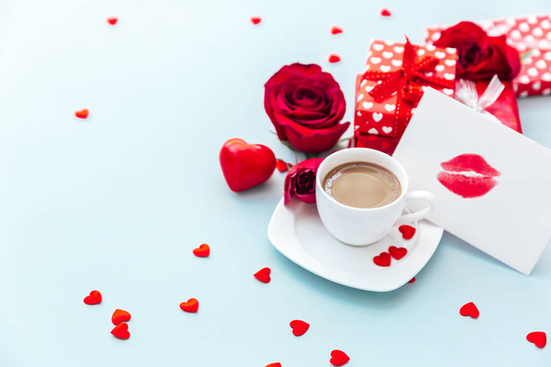 Valentine day composition with coffee cup, rose flower and gift box on table. Top view, flat lay. Holiday concept. - Foto, Imagem