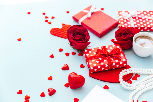 Valentine day composition with coffee cup, rose flower and gift box on table. Top view, flat lay. Holiday concept. - Photo, image