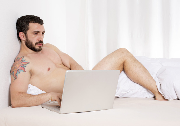 Man in bed with laptop - Photo, Image