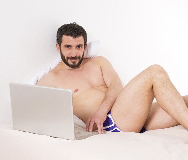 Man in bed with laptop - Photo, Image