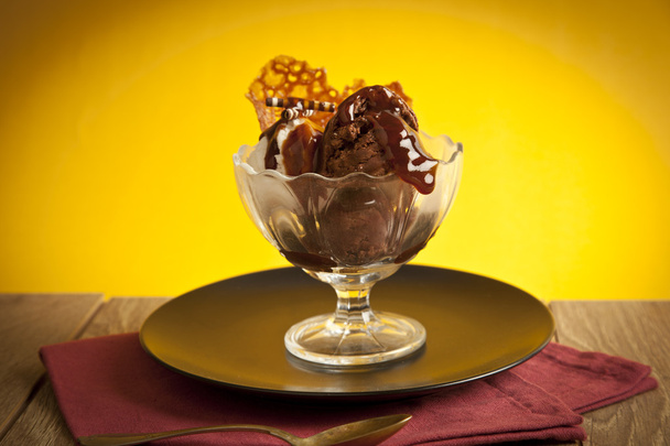 Ice cream in sundae cup on yellow background - Fotó, kép