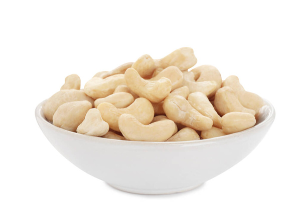 Bowl of tasty organic cashew nuts isolated on white - Photo, Image