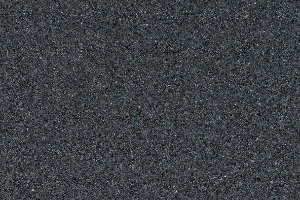Volledig frame van zwart schuurpapier textuur. Schuurmateriaal met een gruizig oppervlak. - Foto, afbeelding
