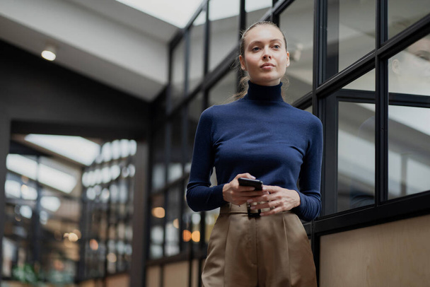 businesswoman manager a young woman holds a phone in her hands,  - Foto, Bild