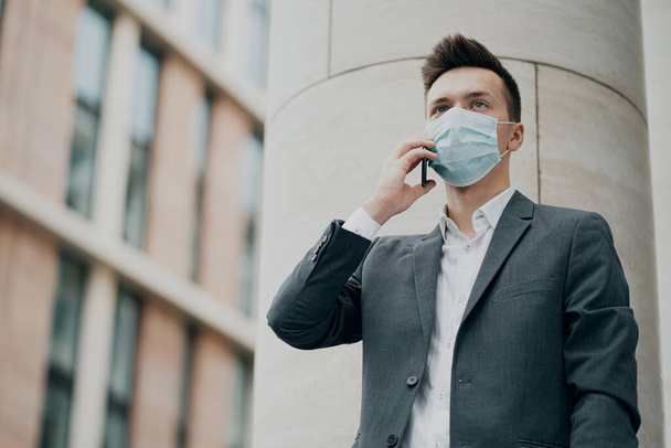 blue protective mask from the coronavirus 19 pandemic on the fac - 写真・画像