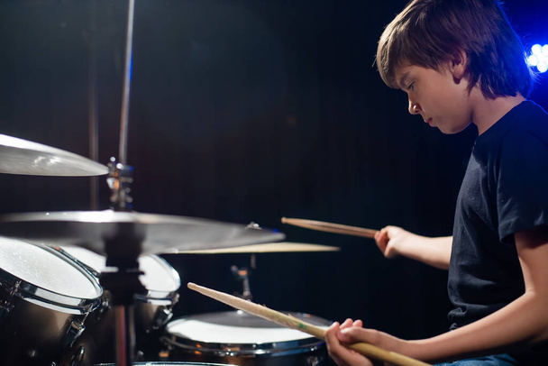 A boy plays drums in a recording studio - Фото, зображення