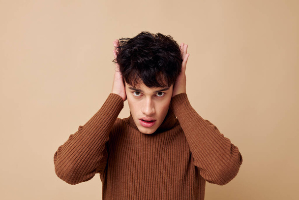 portrait of a young man brown turtleneck posing fashion light background unaltered - Foto, afbeelding