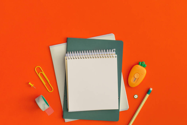 School stationery on red background. Top view with copy space. Flat lay. Back to school concept. - Foto, imagen