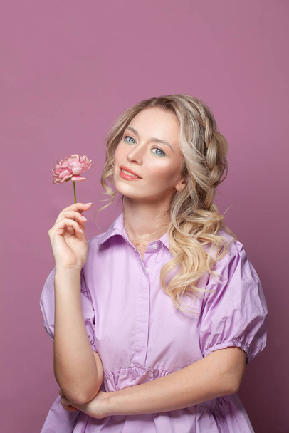 Happy woman with pink flower on pink background - Photo, Image