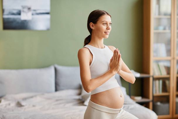 Pregnant woman doing yoga exercises - Foto, immagini