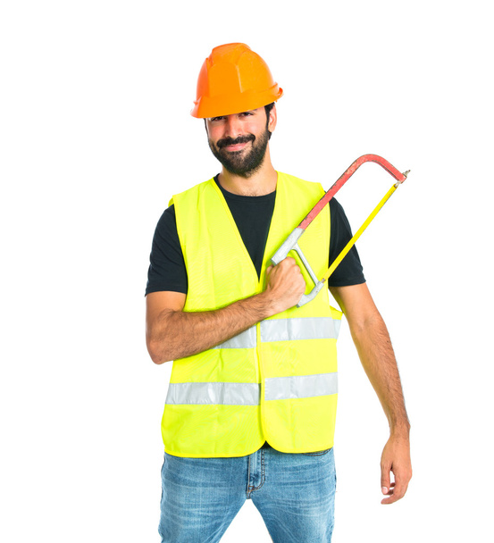 Workman with hacksaw over white background - Фото, зображення