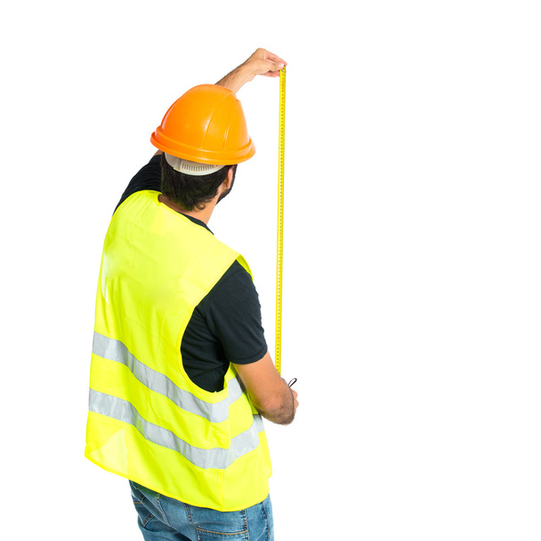 Ouvrier avec compteur sur fond blanc
 - Photo, image