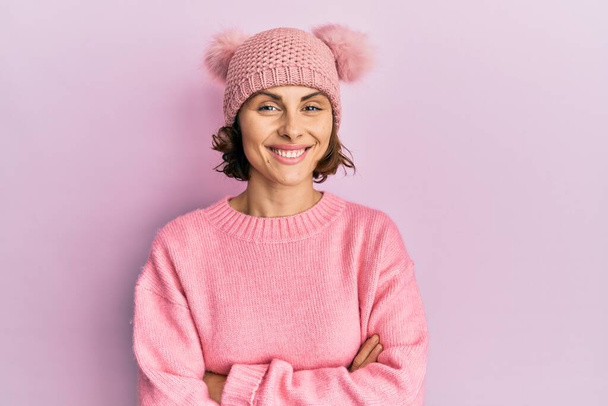 Young brunette woman wearing cute wool cap happy face smiling with crossed arms looking at the camera. positive person.  - Photo, Image